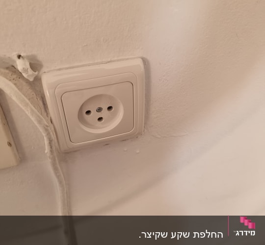 שקע חשמל על קיר לבן